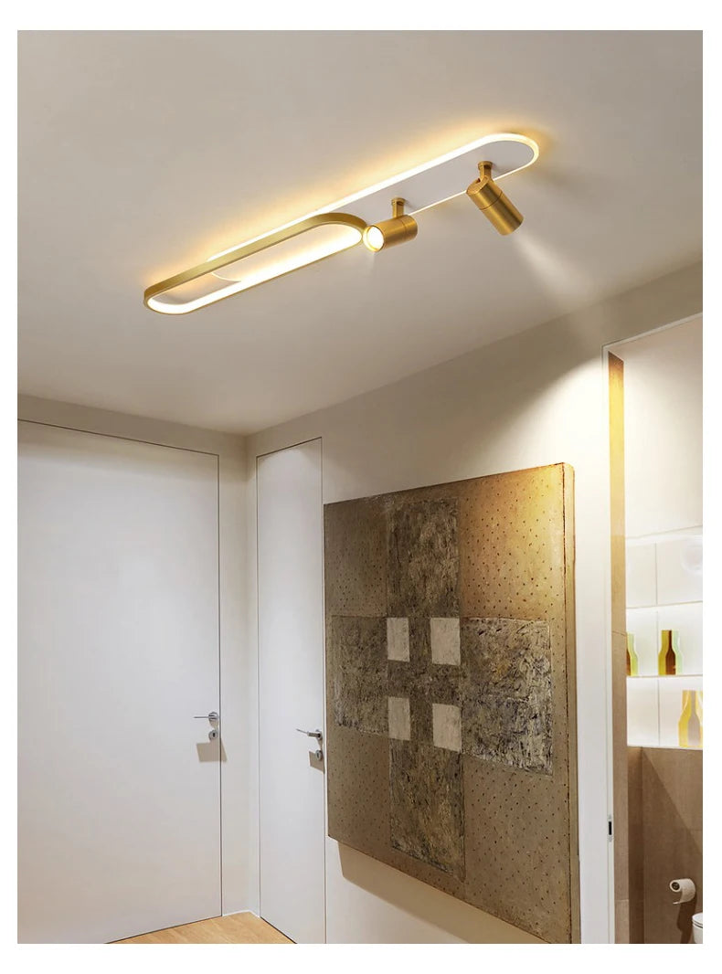 Modern ceiling light fixture in a room with a textured wall and door.