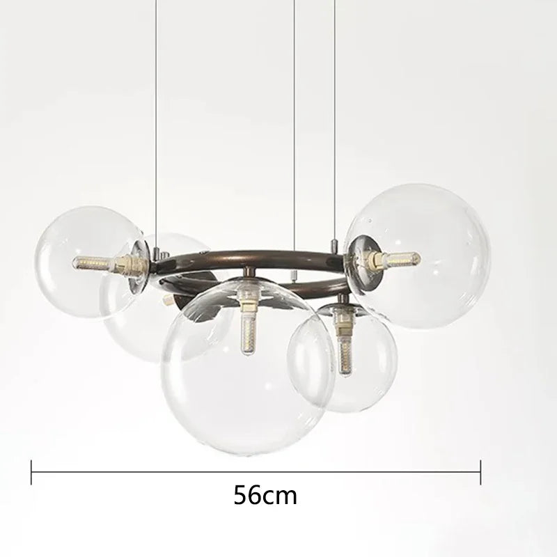 Chandelier with clear glass spheres and metal fixture, shown with dimensions on a white background.