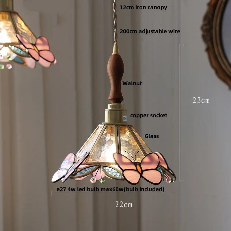 Pendant light with butterfly design and measurement details on a neutral background