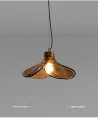 Gold pendant light on a gray background