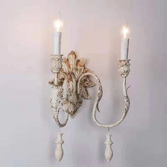 Decorative wall sconce with intricate design on a plain background