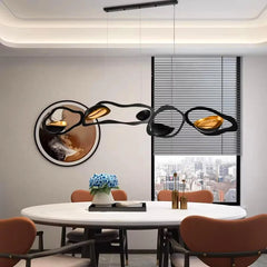 Modern dining room with a large wall sculpture and round table.