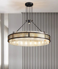Modern chandelier hanging in a room with striped wallpaper