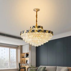 A large gold tiered crystal chandelier installed in a spacious dining room.