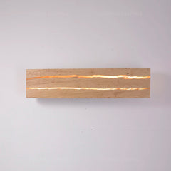 Wooden light fixture with a warm glow on a gray background