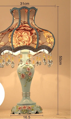 Decorative table lamp with floral design and measurements on a beige background