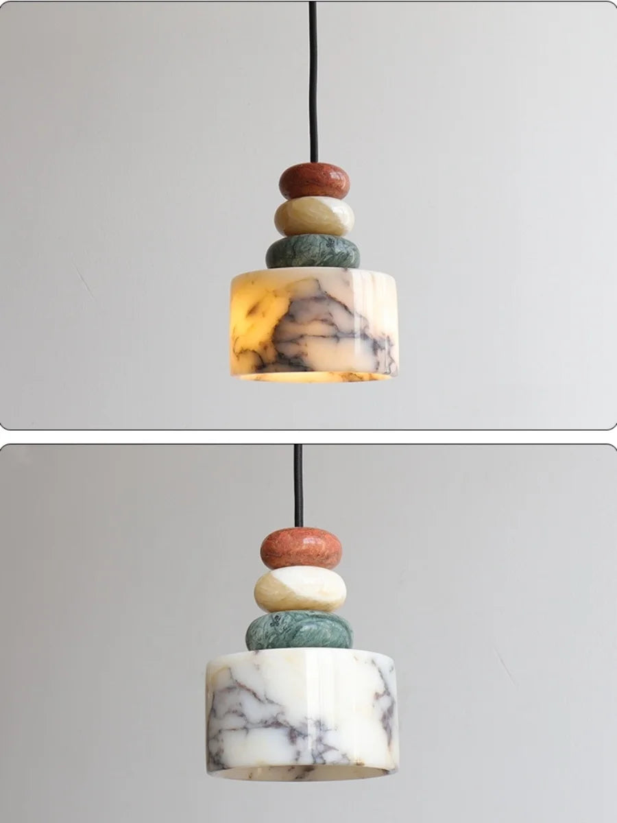 Marble-patterned pendant light with stacked cylindrical stones on a gray background