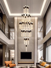 Modern interior with a chandelier hanging above a living room.