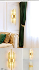 Gold wall sconces on a white wall with a green curtain and beige sofa.