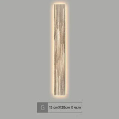 Wall-mounted light fixture with a textured design on a gray background