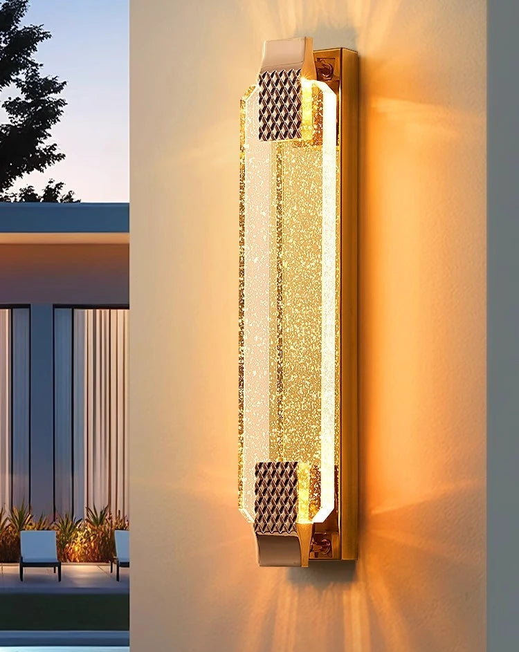 Decorative wall light fixture on a building exterior with a modern design.