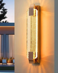 Decorative wall light fixture on a building exterior with a modern design.