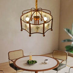 A collection of brushed gold pendant lights with floral motifs and frosted glass, displayed in various room settings.