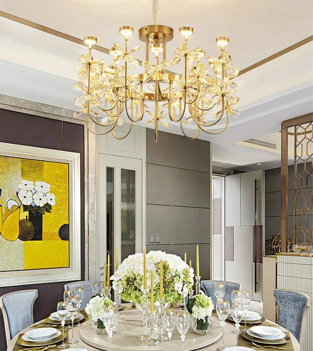 Luxurious dining room with a gold chandelier, table setting, and modern decor.