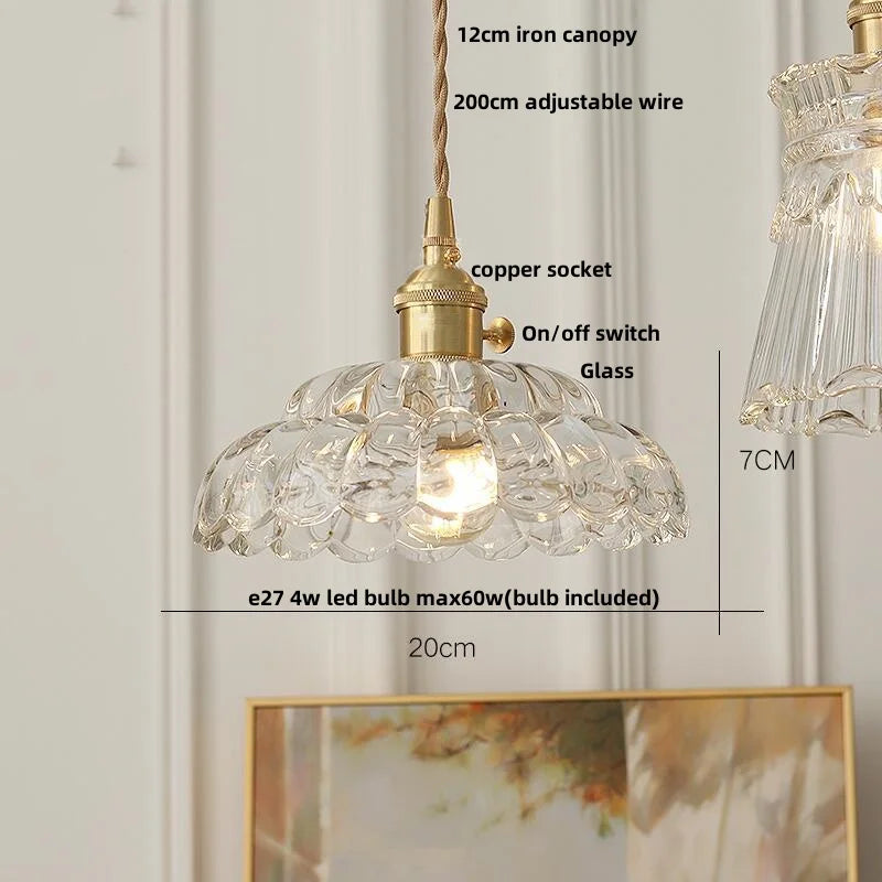 Pendant light with clear glass shade and gold fixture, featuring measurements and bulb information.