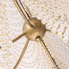 Detail shot of the intricate crystal beadwork and silver metal frame of a wall sconce.