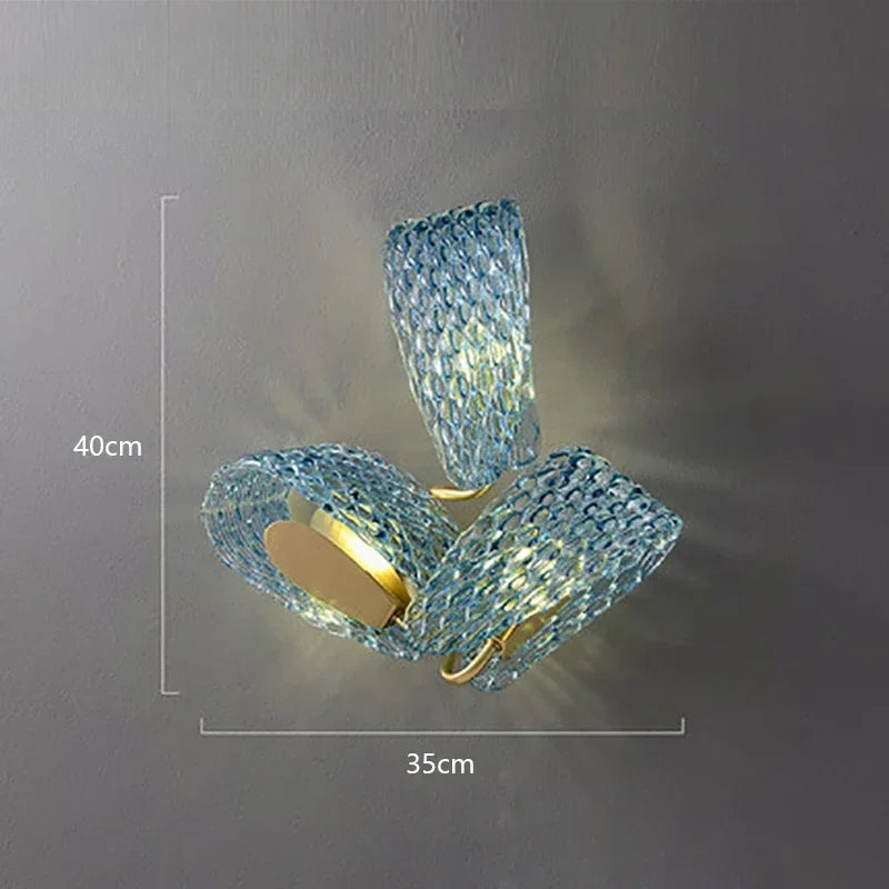 Modern wall light fixture with blue crystal design on a gray background