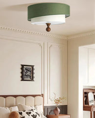 Ceiling light fixture in a room with decorative wall art and furniture.