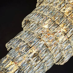 Close-up of a crystal chandelier with clear and gold accents on a black background