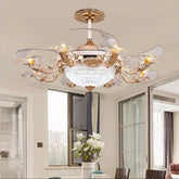 A close-up view of a gold ceiling fan light with ornate floral accents and clear crystal embellishments, set against a white ceiling.