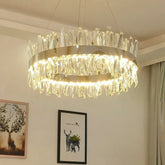 Round crystal ring chandelier with gold finish and cascading crystal droplets, illuminated.