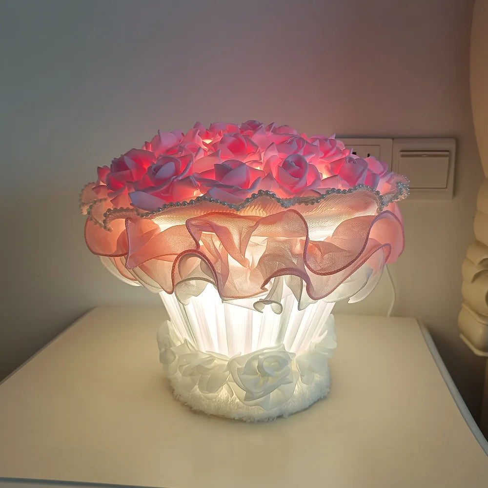 Decorative lamp with pink floral design on a white surface