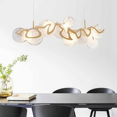 Clear glass discs with gold wavy accents on a pendant light