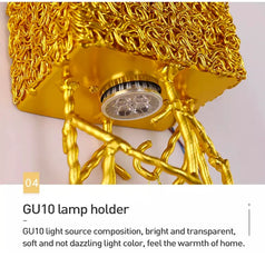Gold GU10 lamp holder with decorative design on a light gray background