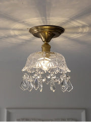 Small chandelier with crystal accents on a ceiling