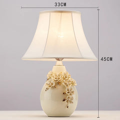 Decorative table lamp with floral design on a gray background
