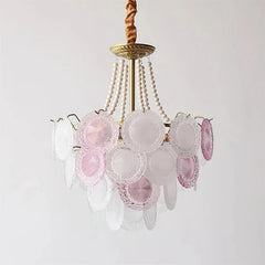Chandelier with pink and clear glass shades on a white background