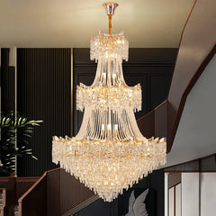Luxurious crystal chandelier hanging in a room with dark paneling and a plant.