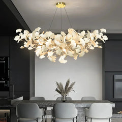 Gold ginkgo leaf cluster pendant light over a dining table