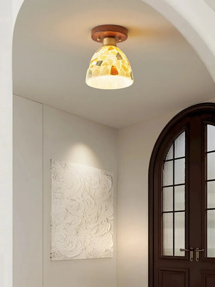 Ceiling light fixture in a room with a door and wall art
