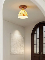 Ceiling light fixture in a room with a door and wall art