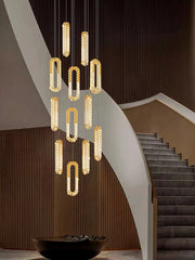 Modern chandelier hanging above a staircase in an elegant interior setting.