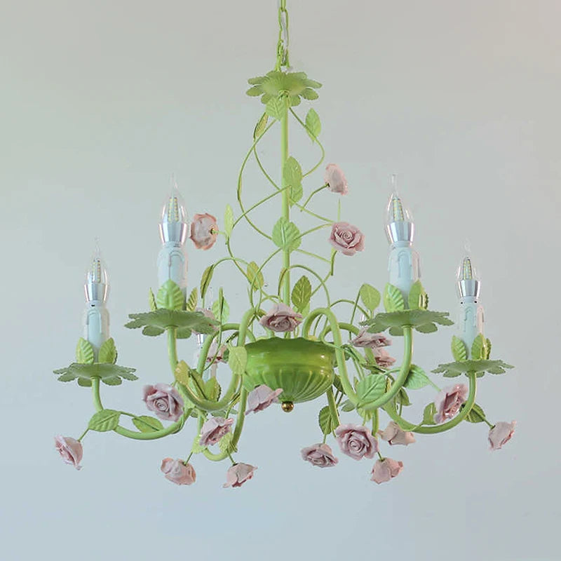 Close-up of the green floral ceramic chandelier detailing the rose and leaf elements.