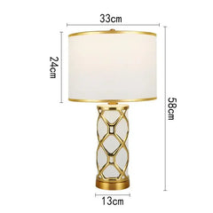 Table lamp with gold base and white shade, shown with dimensions on a white background