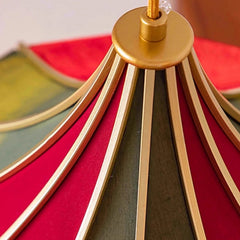 Close-up of a red and gold lampshade with a blurred background