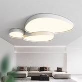 White cloud-shaped LED semi-flush mount ceiling light illuminating a modern living room with a sectional sofa.