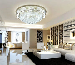 Modern living room with a chandelier, white sofa, and decorative elements.