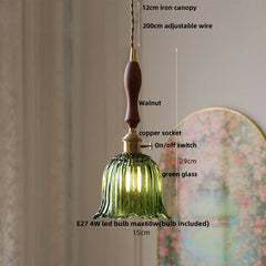Green glass pendant light with measurements and features on a neutral background