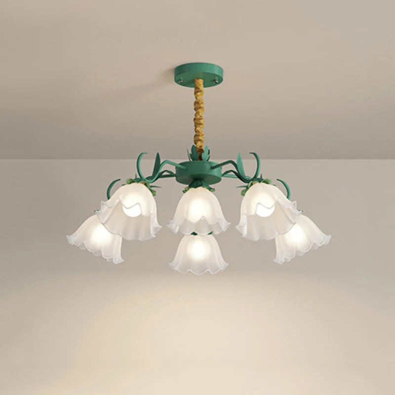 Close-up of the green floral pendant light, showing the details of the glass shades and metal stem.