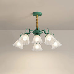 Close-up of the green floral pendant light, showing the details of the glass shades and metal stem.