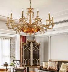 Luxurious living room with a grand chandelier, elegant furniture, and decorative elements.