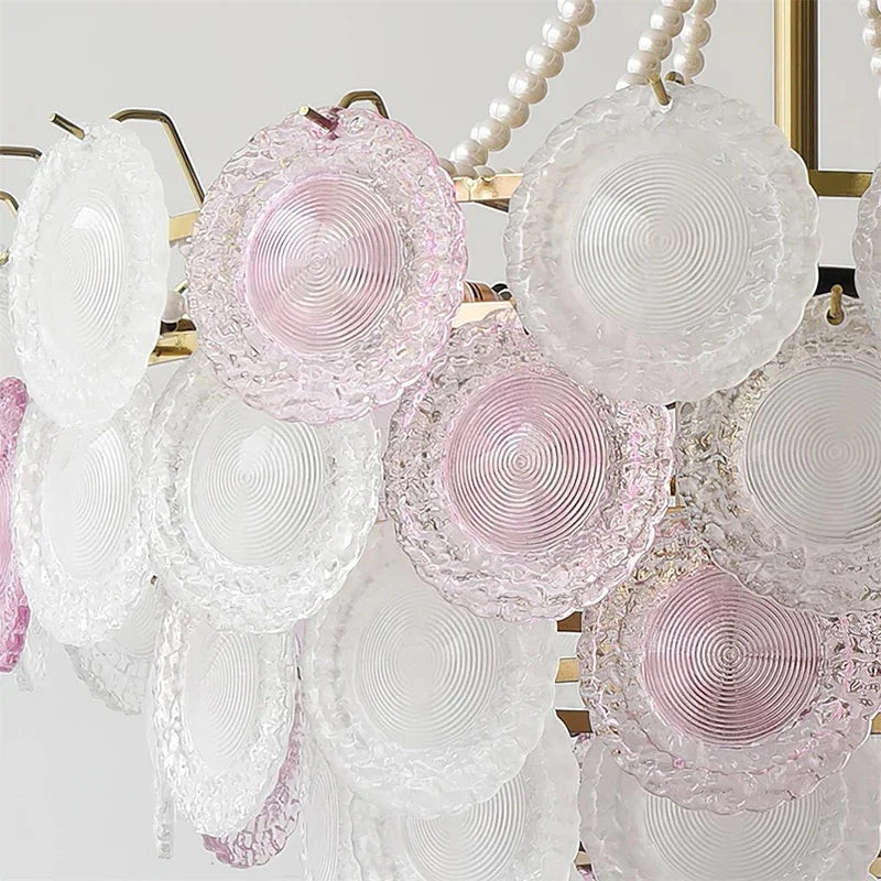 Decorative wall art with circular pink and white plates on a light background