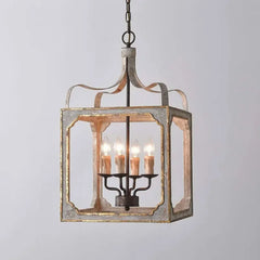 Distressed gray and gold lantern chandelier with four candelabra bulbs, shown against a white background.