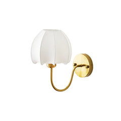 Wall sconce with white shade and gold metal arm on a white background