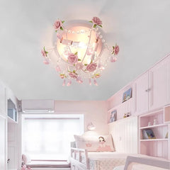 A pink rose bouquet semi-flush ceiling light installed in a child's bedroom with pink cabinetry and twin beds.