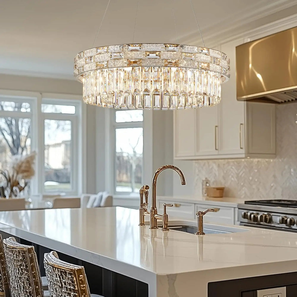 Gold crystal tiered ring chandelier installed in a modern kitchen island setting.